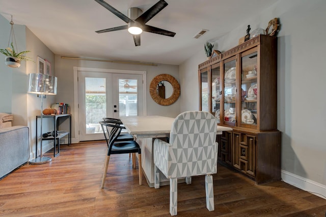 dining space featuring french doors, hardwood / wood-style flooring, and ceiling fan