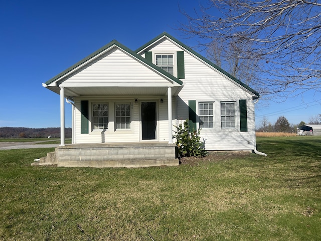 view of front of property featuring covered porch and a front yard