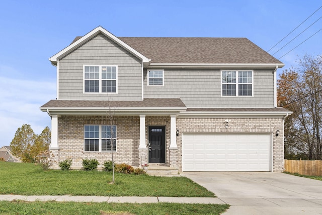 view of front of property with a front yard and a garage