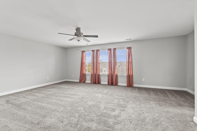 carpeted empty room featuring ceiling fan