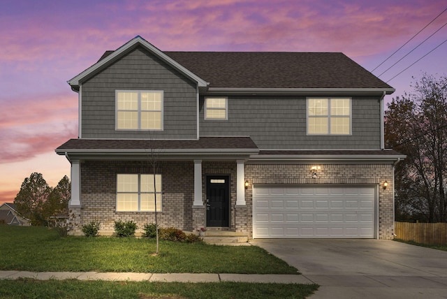 view of front of house featuring a garage and a yard