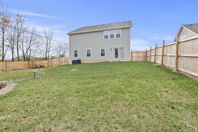 rear view of property featuring a lawn