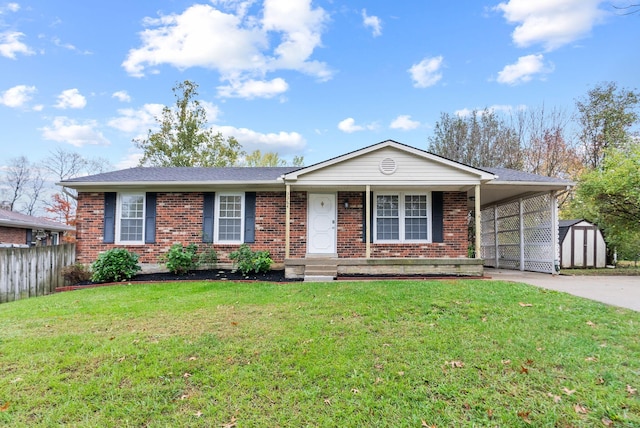 ranch-style home featuring a front yard, a carport, and a storage unit