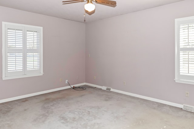 carpeted empty room with ceiling fan and a healthy amount of sunlight