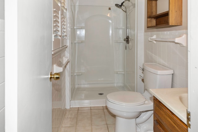 bathroom with walk in shower, vanity, tile walls, tile patterned flooring, and toilet