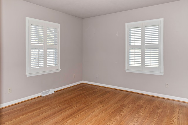 unfurnished room with light hardwood / wood-style flooring