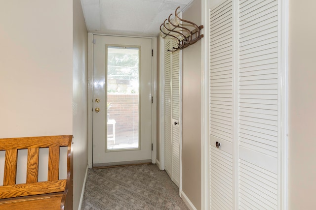 doorway to outside with carpet floors