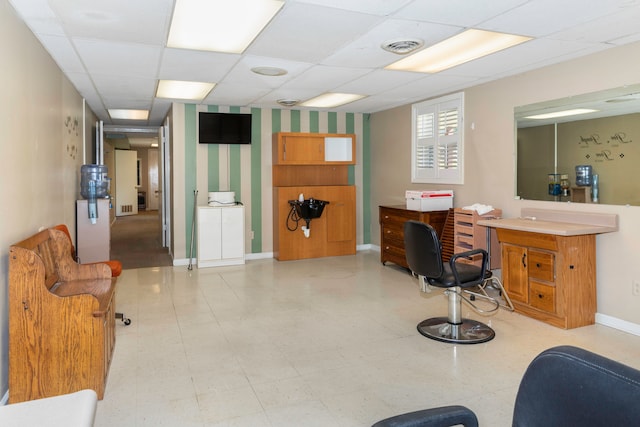 interior space featuring a drop ceiling