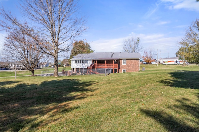 rear view of property featuring a yard