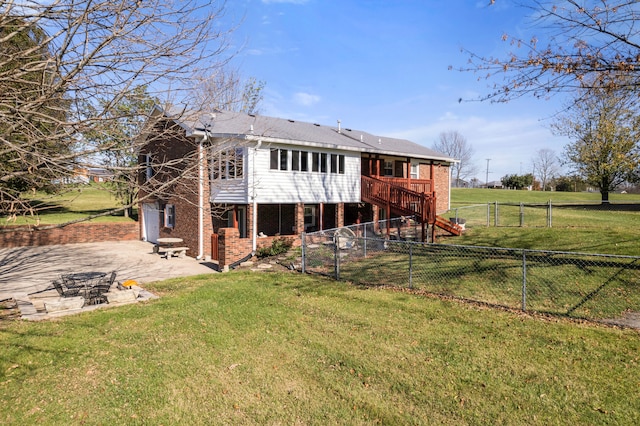 back of house featuring a patio, a wooden deck, and a lawn