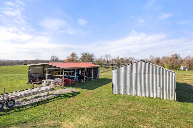 view of yard with a rural view and an outdoor structure