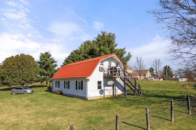 view of property exterior featuring a yard and a wooden deck