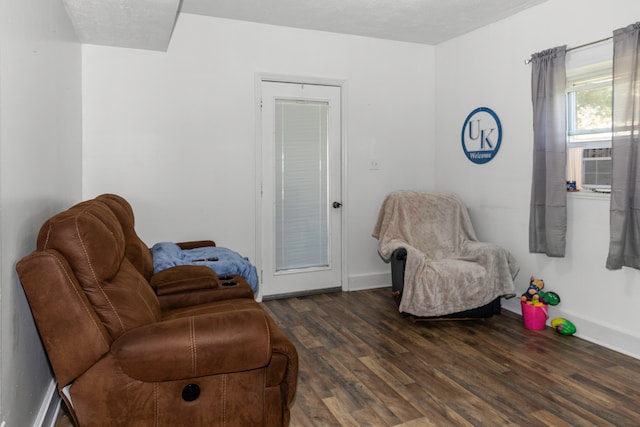 living area featuring a textured ceiling, cooling unit, and dark wood-type flooring