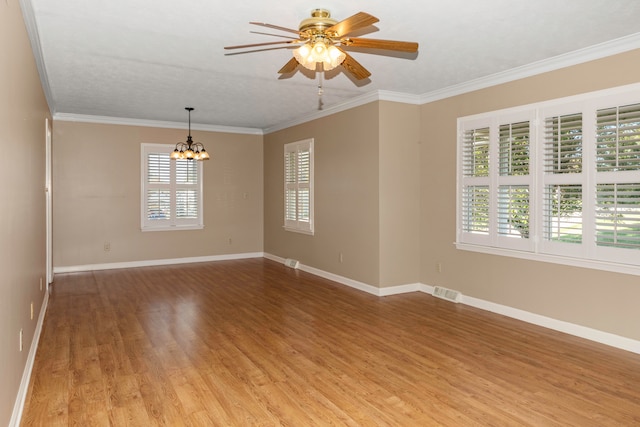 unfurnished room with a textured ceiling, light hardwood / wood-style flooring, ceiling fan with notable chandelier, and ornamental molding