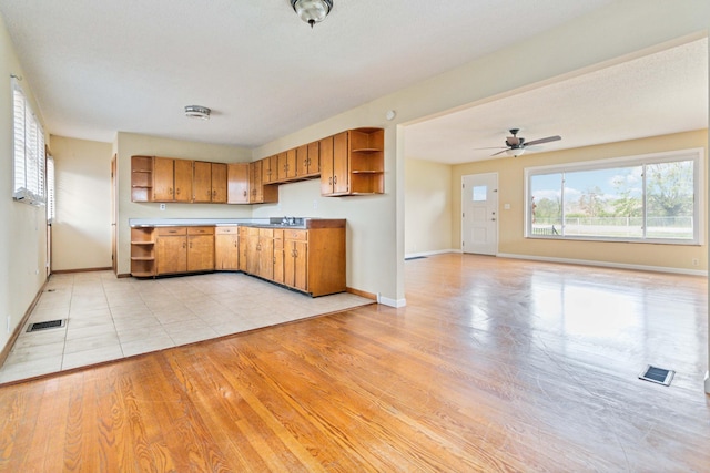 kitchen featuring ceiling fan, light hardwood / wood-style floors, and sink