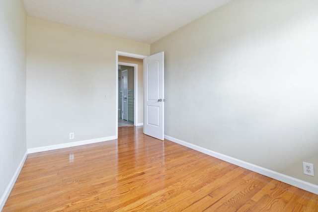 spare room with light hardwood / wood-style flooring