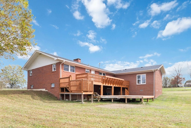 rear view of property with a yard and a wooden deck