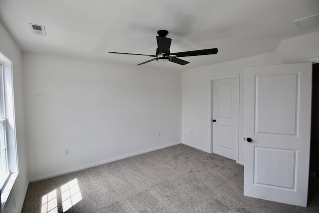 unfurnished bedroom featuring light carpet, a closet, and ceiling fan