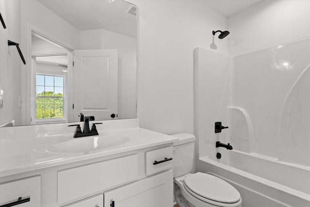 full bathroom featuring toilet, vanity, and washtub / shower combination