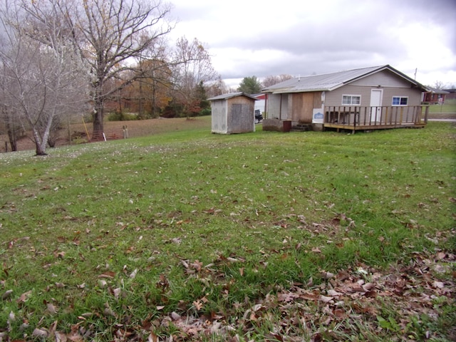 view of yard with a shed and a deck