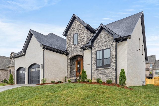 view of front of property with a front yard and a garage