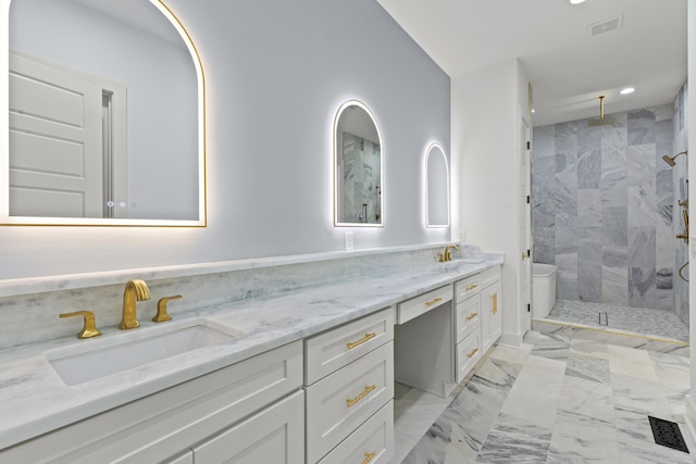 bathroom with vanity and tiled shower