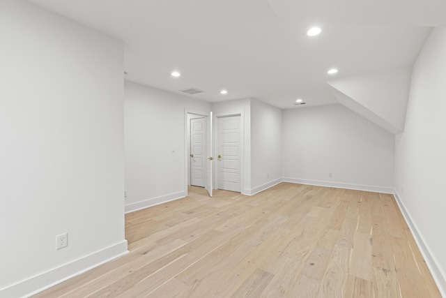 additional living space with light hardwood / wood-style floors