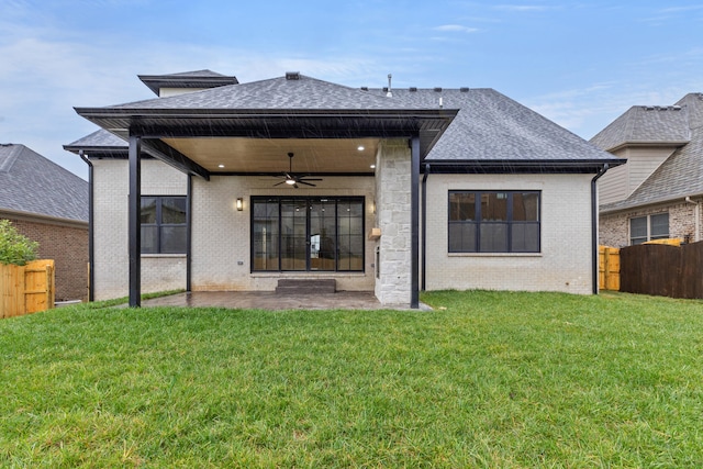 back of property featuring a yard, ceiling fan, and a patio area