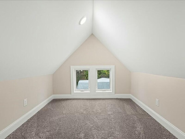 bonus room with carpet and vaulted ceiling