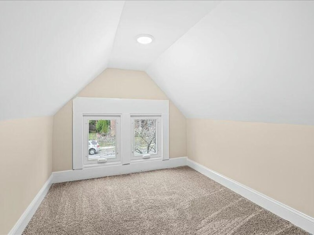 bonus room featuring carpet floors and vaulted ceiling