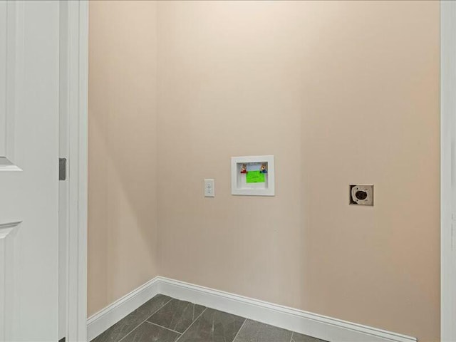 washroom featuring washer hookup, dark tile patterned flooring, and hookup for an electric dryer