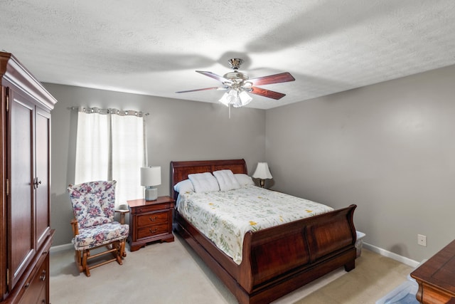 bedroom with light carpet, a textured ceiling, and ceiling fan