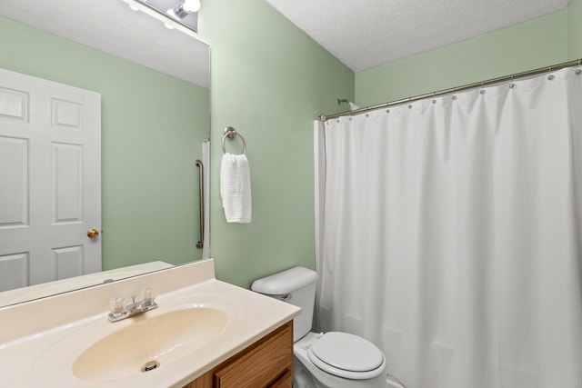 bathroom featuring a shower with curtain, vanity, toilet, and a textured ceiling