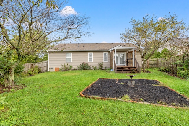 back of property with a yard and a deck