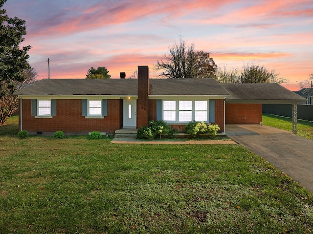 ranch-style home featuring a yard and a carport