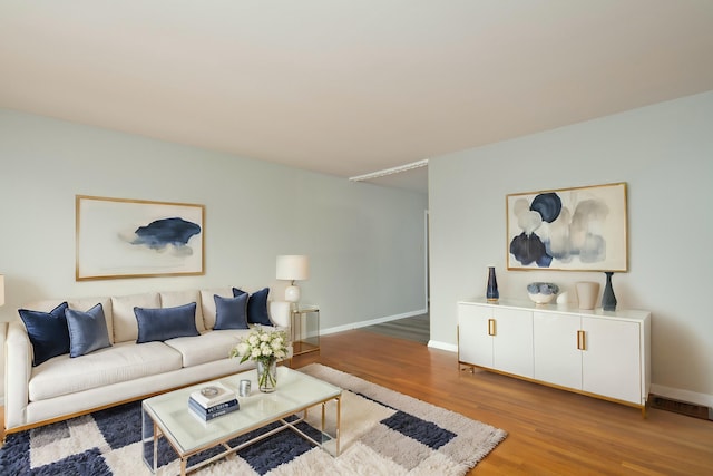 living area featuring wood finished floors and baseboards