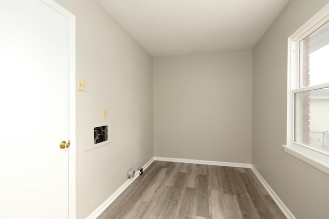 laundry area with laundry area, baseboards, washer hookup, and wood finished floors