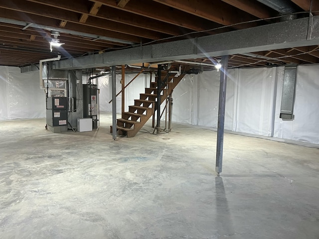 unfinished basement featuring heating unit, water heater, and stairway