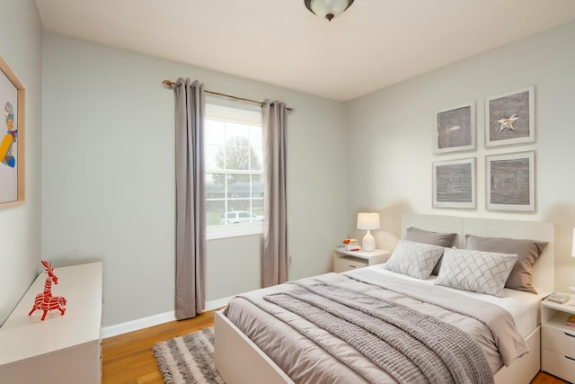 bedroom featuring light wood-style flooring and baseboards