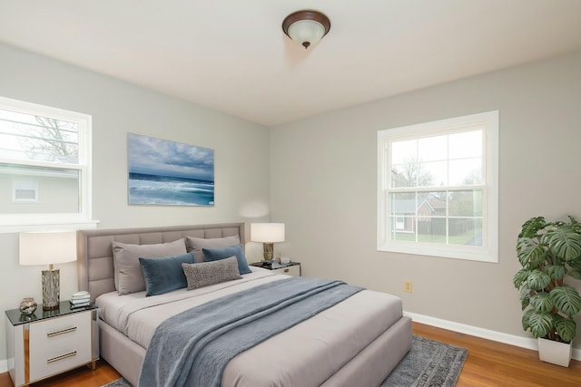 bedroom featuring baseboards and wood finished floors