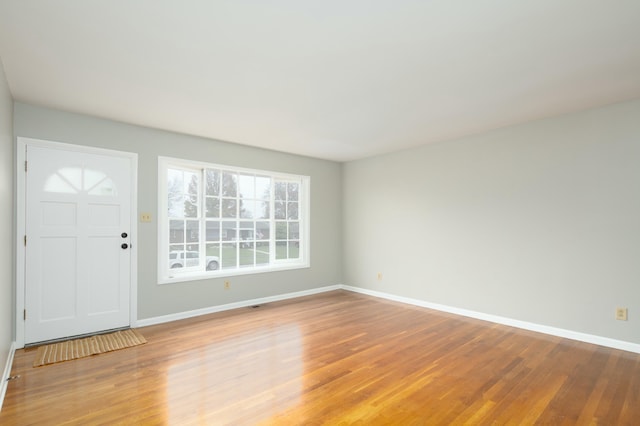 entryway with light wood-type flooring and baseboards