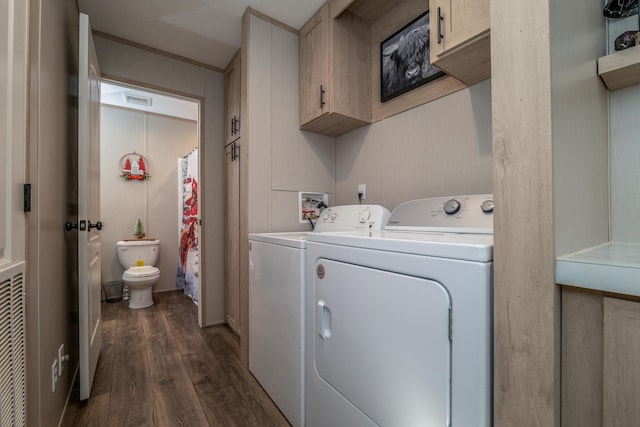 washroom with cabinets, dark hardwood / wood-style floors, and washing machine and clothes dryer