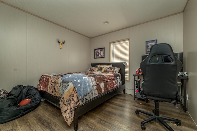 bedroom with dark hardwood / wood-style floors and crown molding