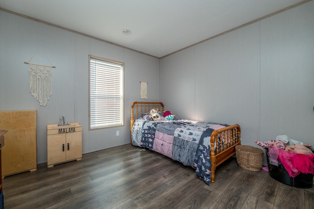 bedroom with dark hardwood / wood-style flooring and crown molding