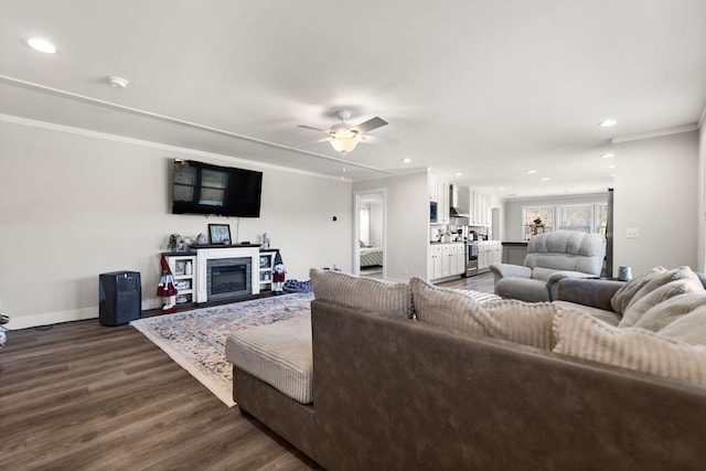 living room with ceiling fan, wood-type flooring, and ornamental molding