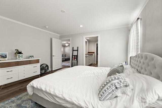 bedroom with ensuite bathroom, dark hardwood / wood-style floors, and ornamental molding