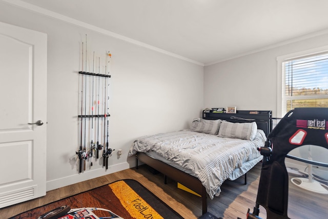 bedroom with hardwood / wood-style floors and ornamental molding