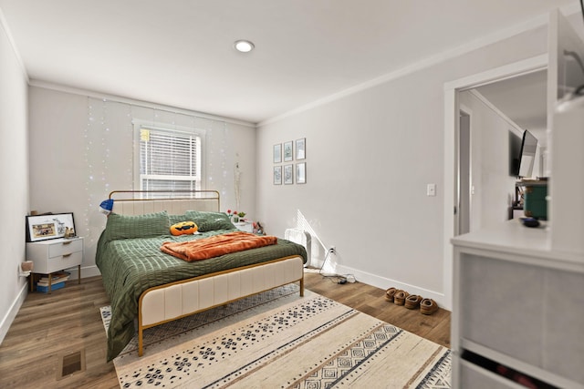 bedroom featuring hardwood / wood-style flooring and ornamental molding