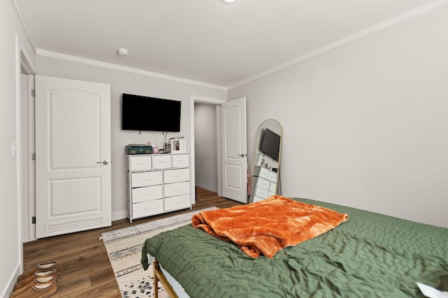 bedroom featuring dark hardwood / wood-style floors and ornamental molding