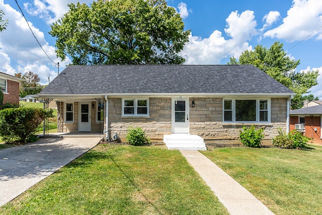 view of front of house with a front yard and central air condition unit